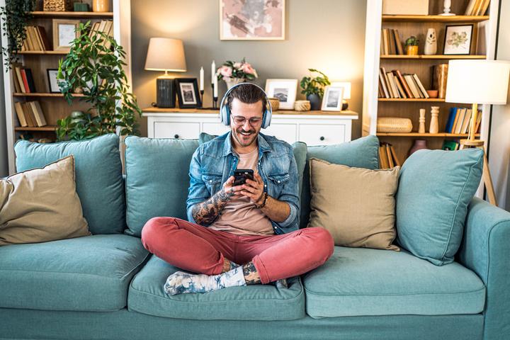 Man on phone sitting on sofa